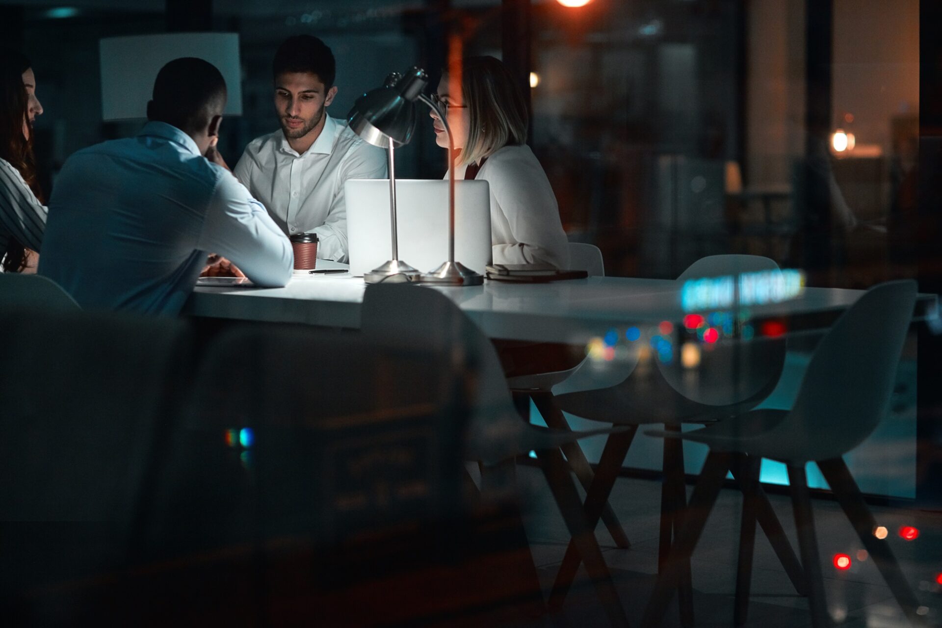 Group, brainstorming and night in meeting, laptop and planning of teamwork, deadline and project for website. Business, computer and admin assistant, online and people in boardroom, dark and startup